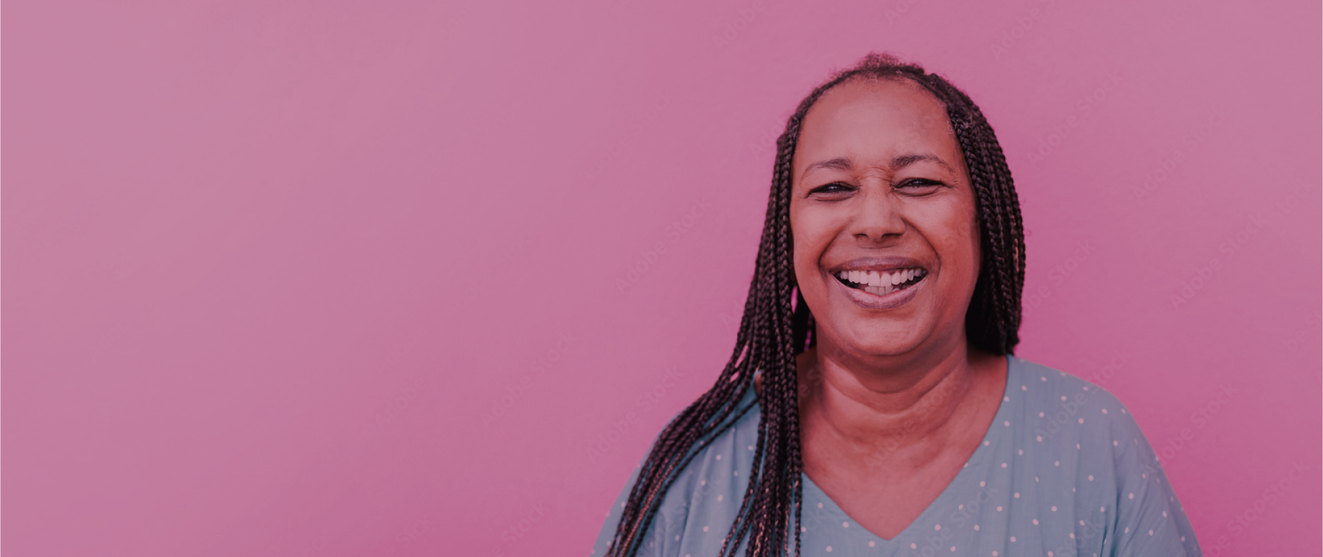 Black woman smiling on pink background