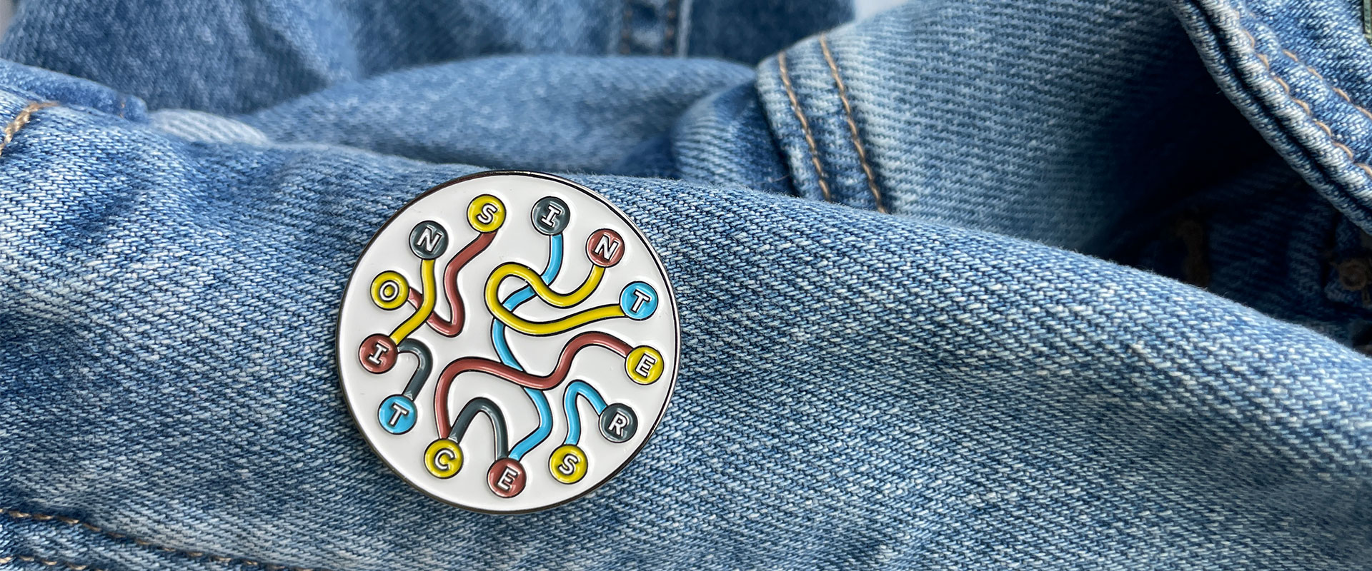 Intersections pin on denim jacket