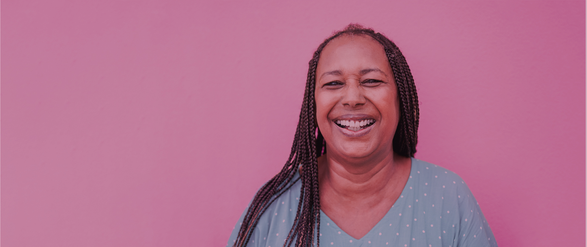 Image of a black woman smiling with pink overlay